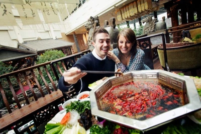 Guest enjoying spicy sichuan style hotpot