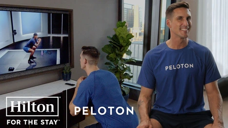 A smart looking peloton trainer doing fitness in a Hilton hotel room