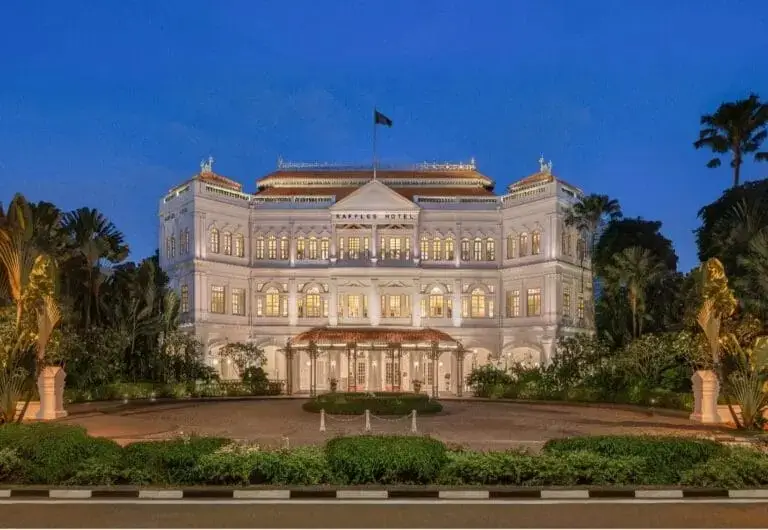 front entrance of the Raffles Singapore at twilight